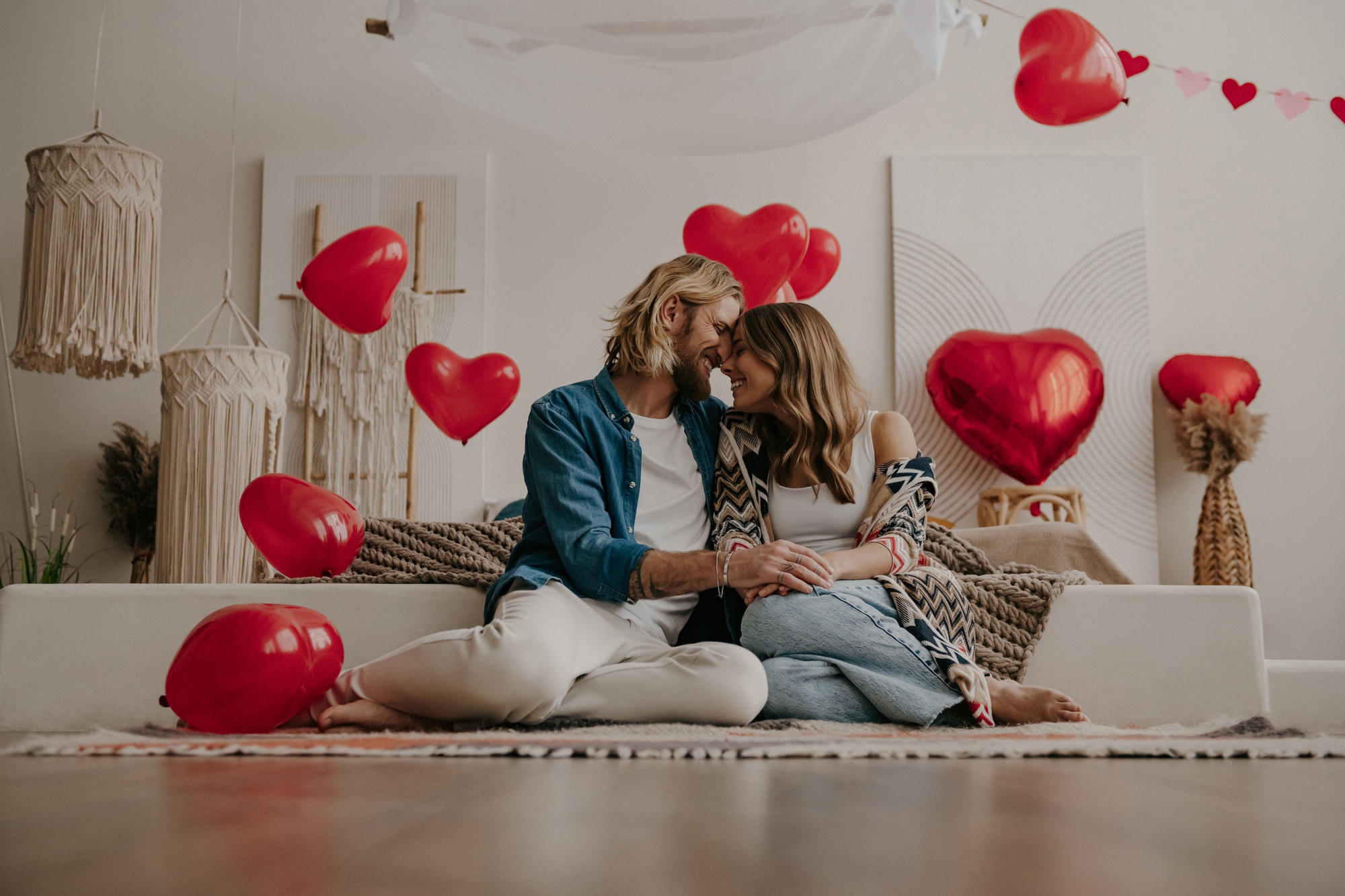 Beautiful loving couple embracing and leaning on bed at home
